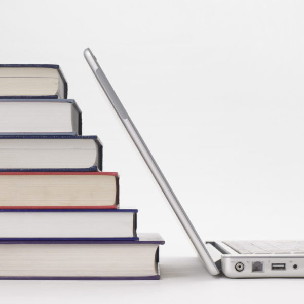 Stack of books and laptop computer